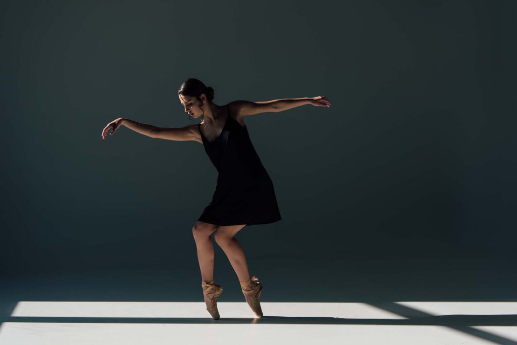 graceful-young-ballerina-dancing-in-black-dress-an-BUNA664.jpg